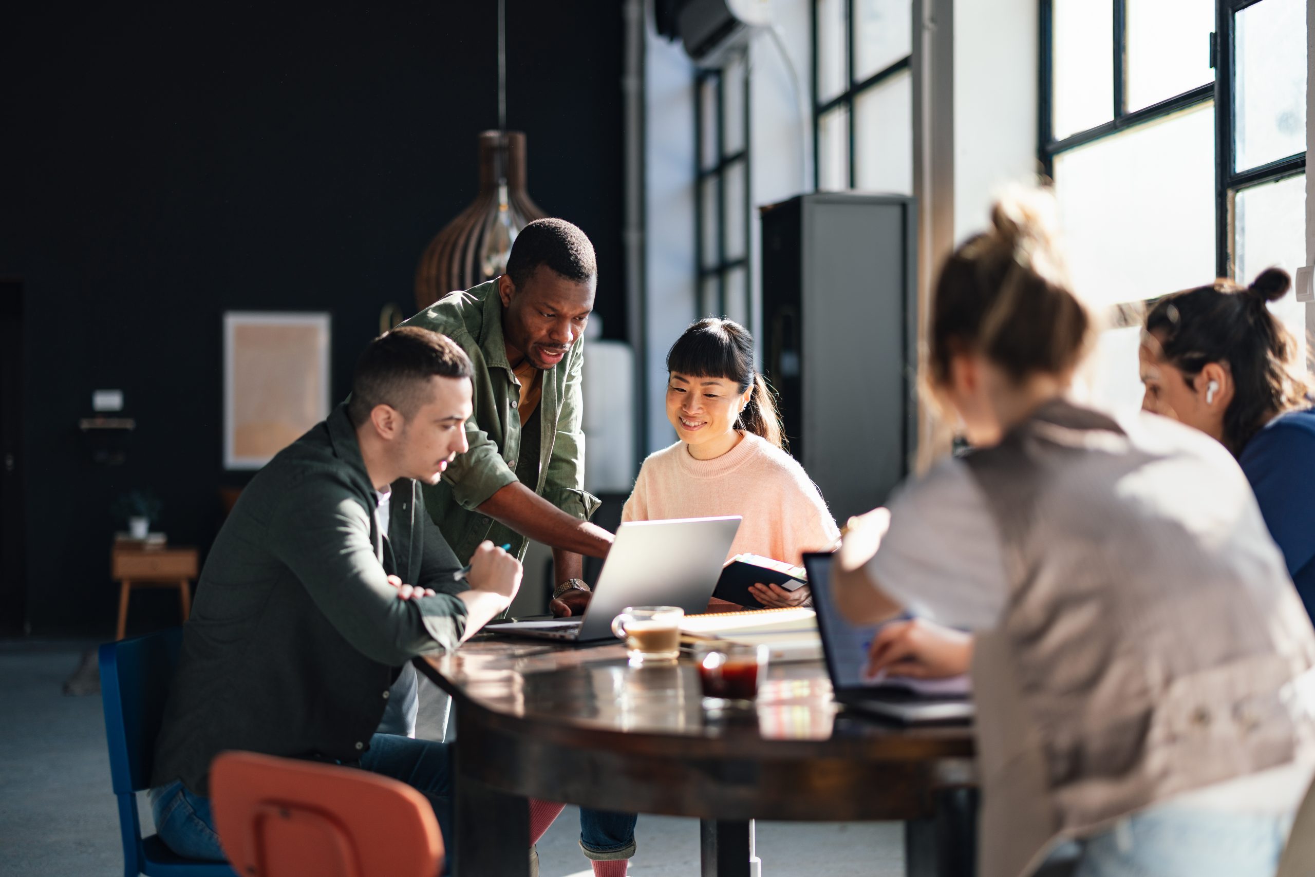Diverse team working together in modern co working space